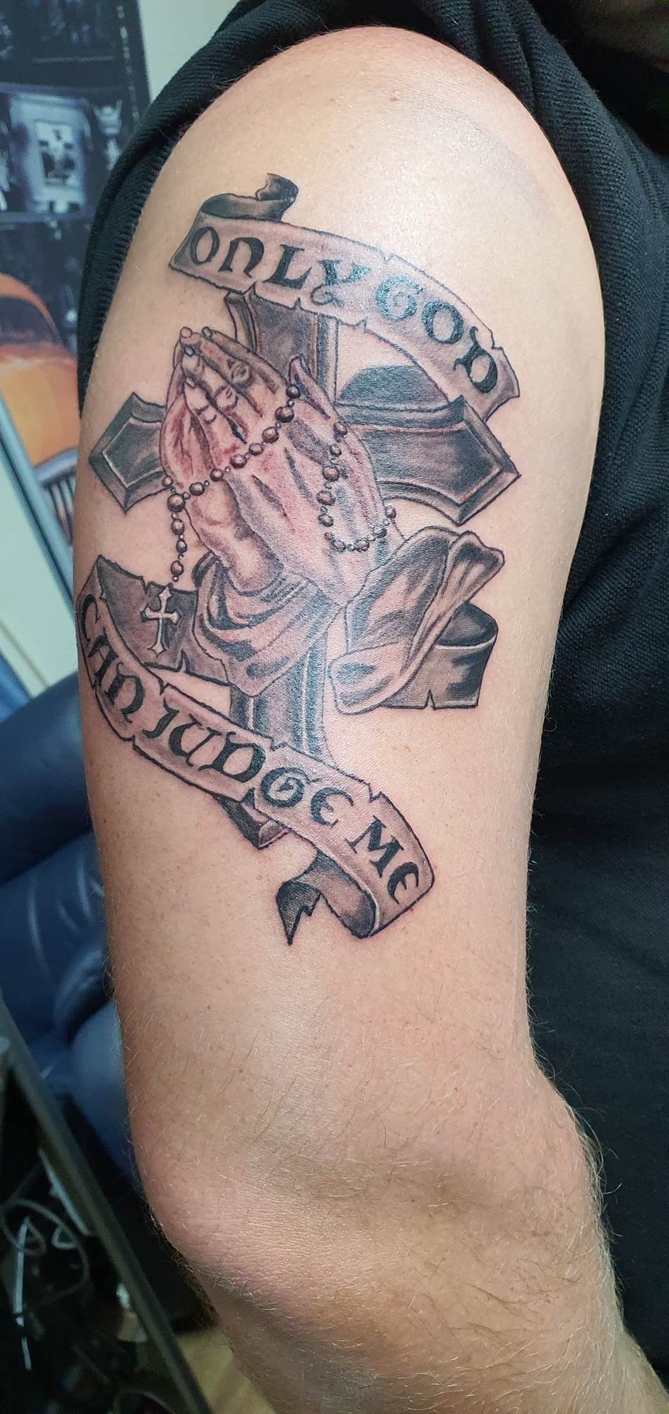 A tattoo of a nun holding a cross