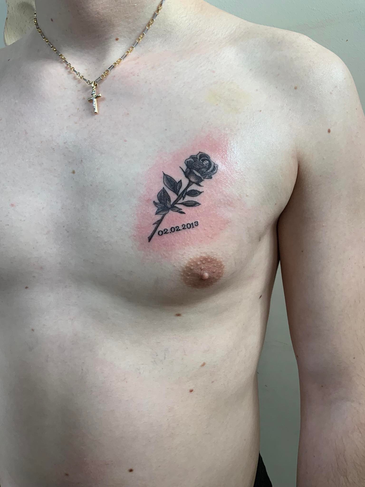 Tattoo of a rose on a man's chest